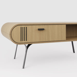 Close-up view of the Jual Furnishings Milano Collection coffee table, showcasing its oak finish, black metal legs, and sleek curved edges. Features a sliding door with a modern black handle and vertical cutout detail for added style. A perfect blend of elegance and functionality for contemporary living spaces