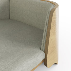 This close-up image highlights the fine craftsmanship of the oak pet bed, showcasing the smooth curved wooden frame and soft woven fabric cushion