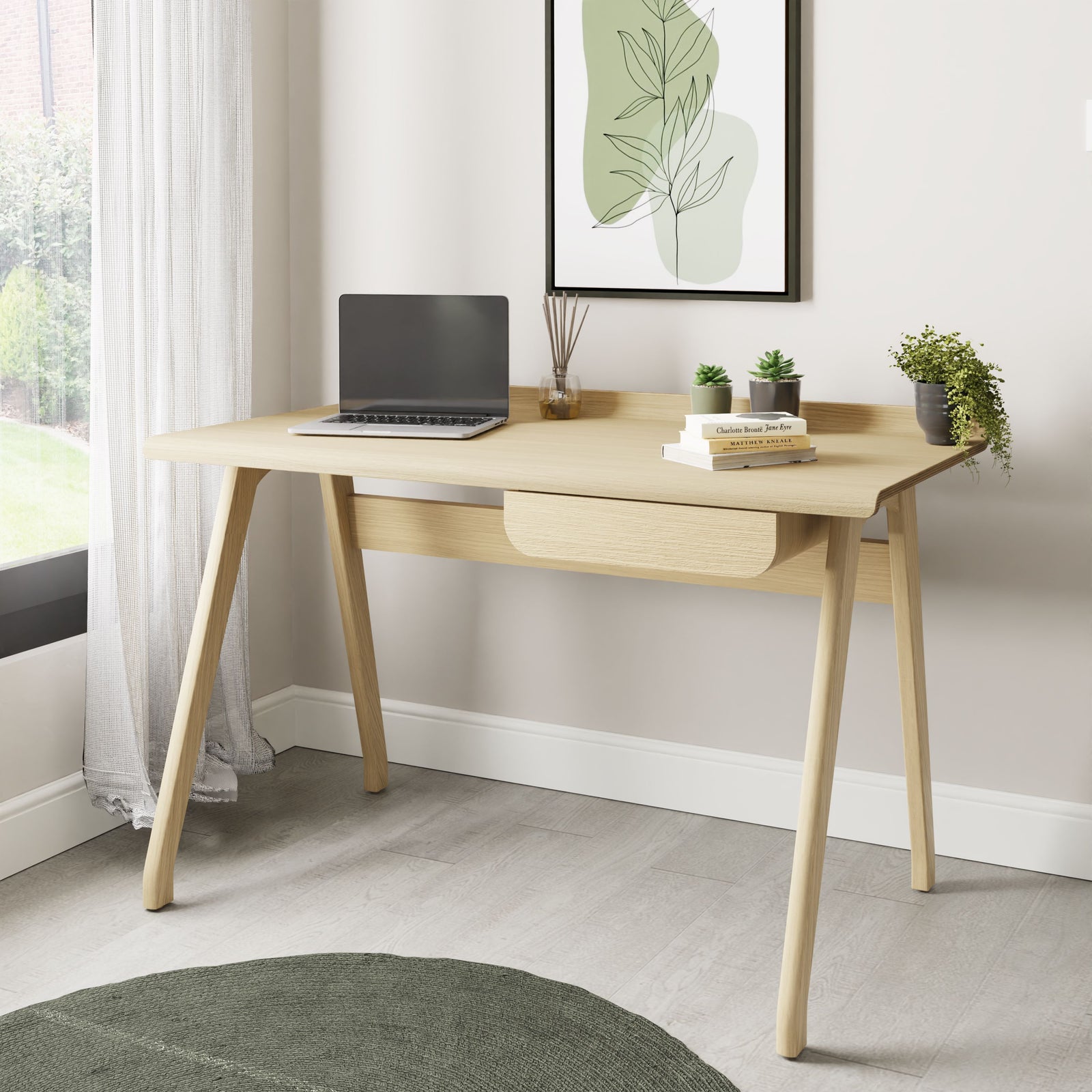 Jual Furnishings PC811 Oak Desk, featuring a sleek Scandinavian design with a natural oak finish. Includes a raised curved back panel, a discreet storage drawer, and sturdy angled legs for a modern workspace.