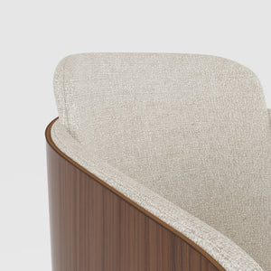 Close-up of the Jual Furnishings chair's curved walnut-finished wood side panel, showcasing its smooth grain, rich tone, and seamless transition into the beige upholstered seat